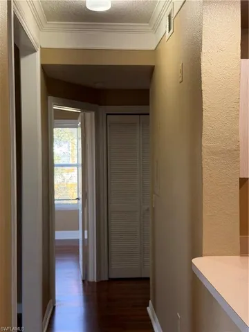a view of a hallway with wooden floor
