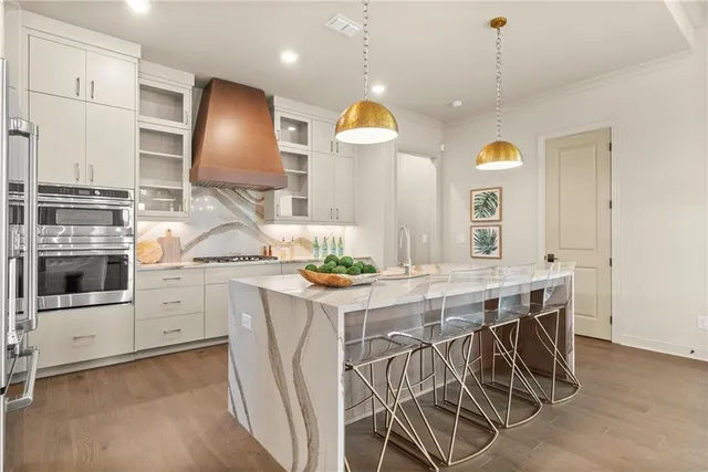 a kitchen with stainless steel appliances kitchen island a large island in the center