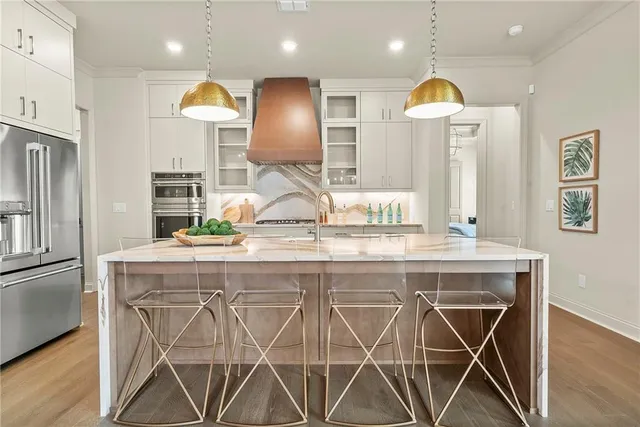 a kitchen with stainless steel appliances kitchen island a chandelier