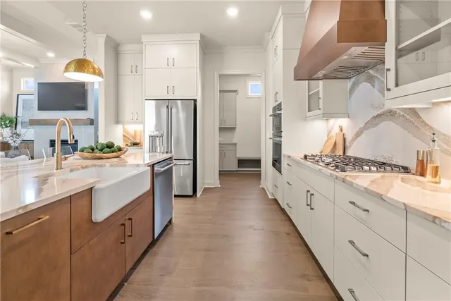 a large kitchen with a large counter top appliances and cabinets