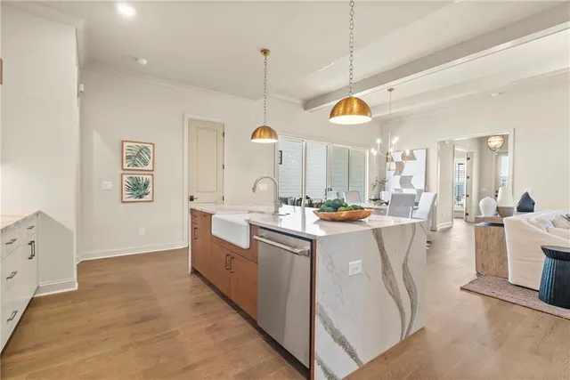 a large kitchen with kitchen island a stove a sink a dining table and chairs