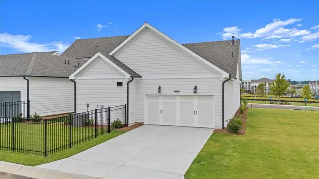 a view of a house with a backyard and a garage