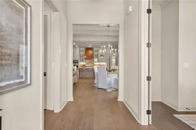 a view of a hallway with living room and dining room view