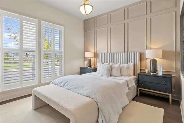 a bedroom with a bed and a large window