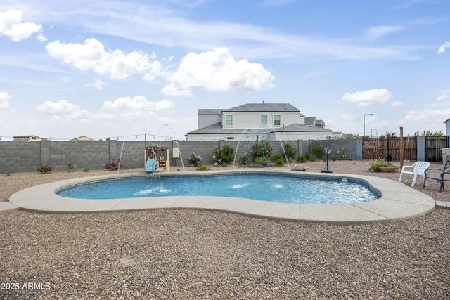 a view of a swimming pool with a yard