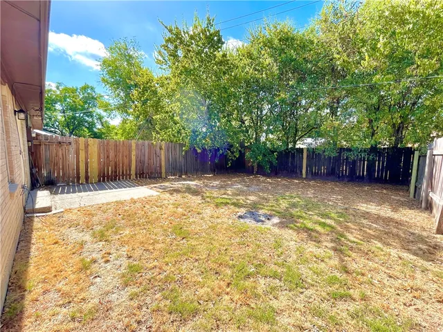 a view of a backyard of the house