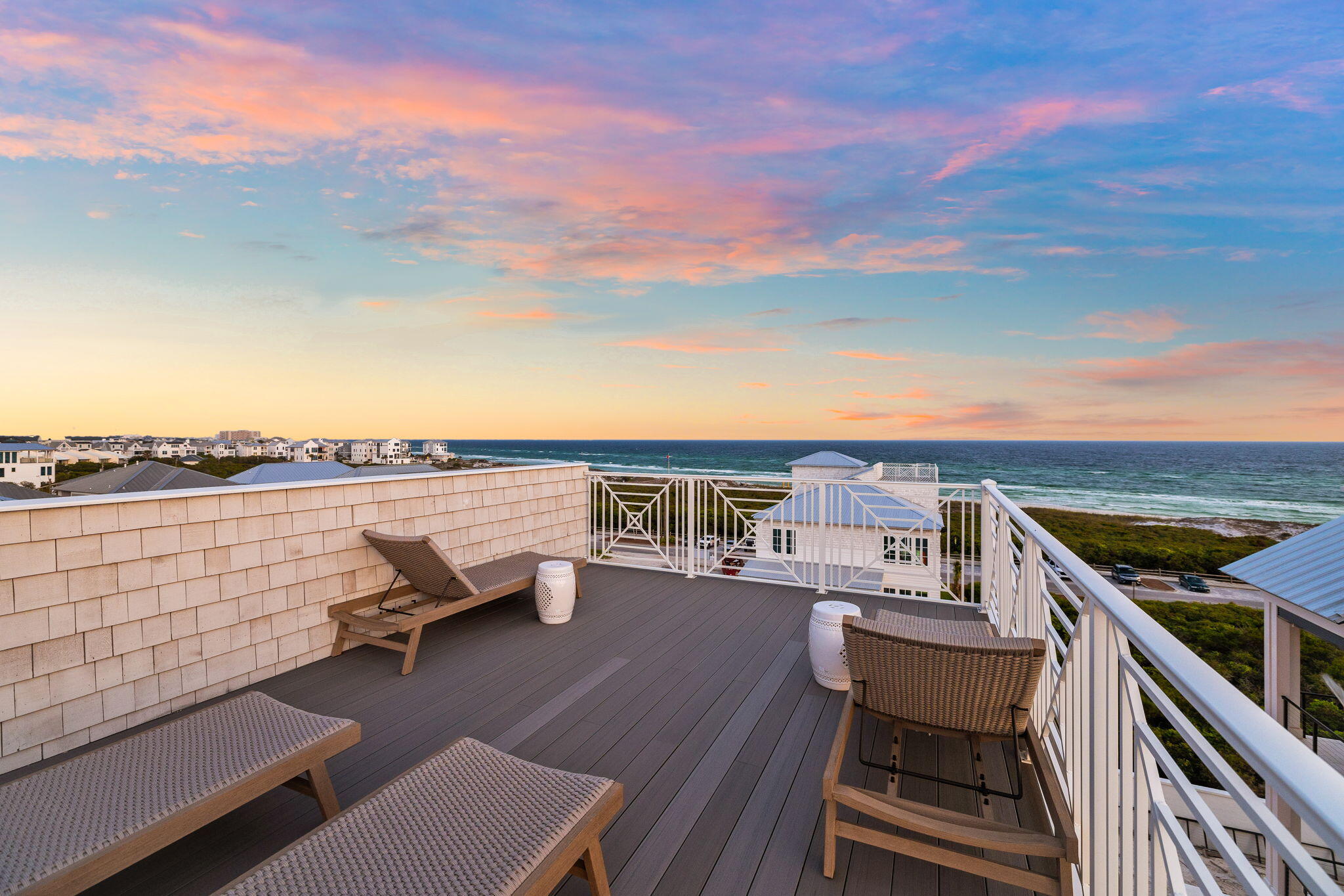 55 Pompano Street Inlet Beach, FL 32461 - Photo 28 of 122 a view of a balcony with table and chairs and wooden floor