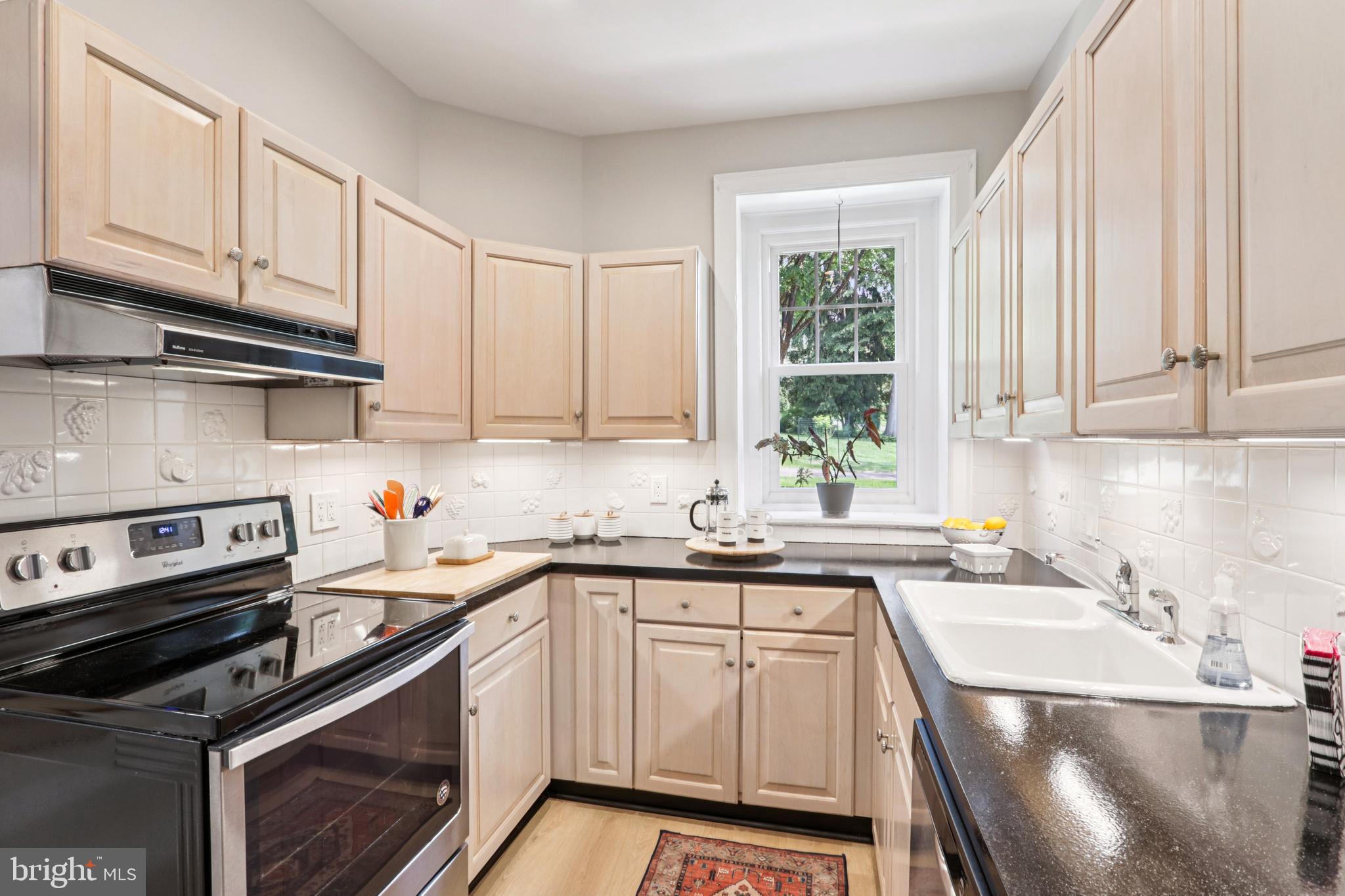 1523 Susquehanna Road Rydal, PA 19046 - Photo 25 of 69 a kitchen with a sink stove and cabinets