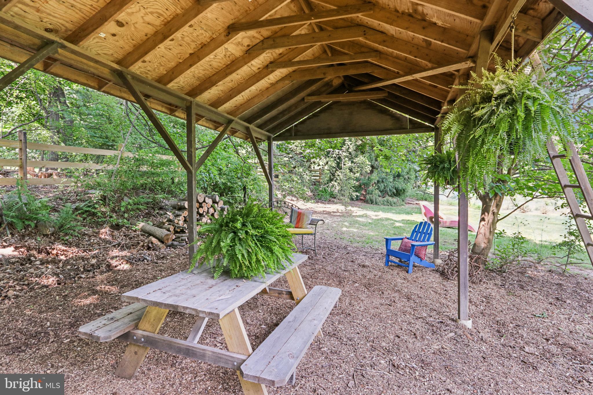 1523 Susquehanna Road Rydal, PA 19046 - Photo 48 of 69 a view of an outdoor space with a table and chairs under an umbrella