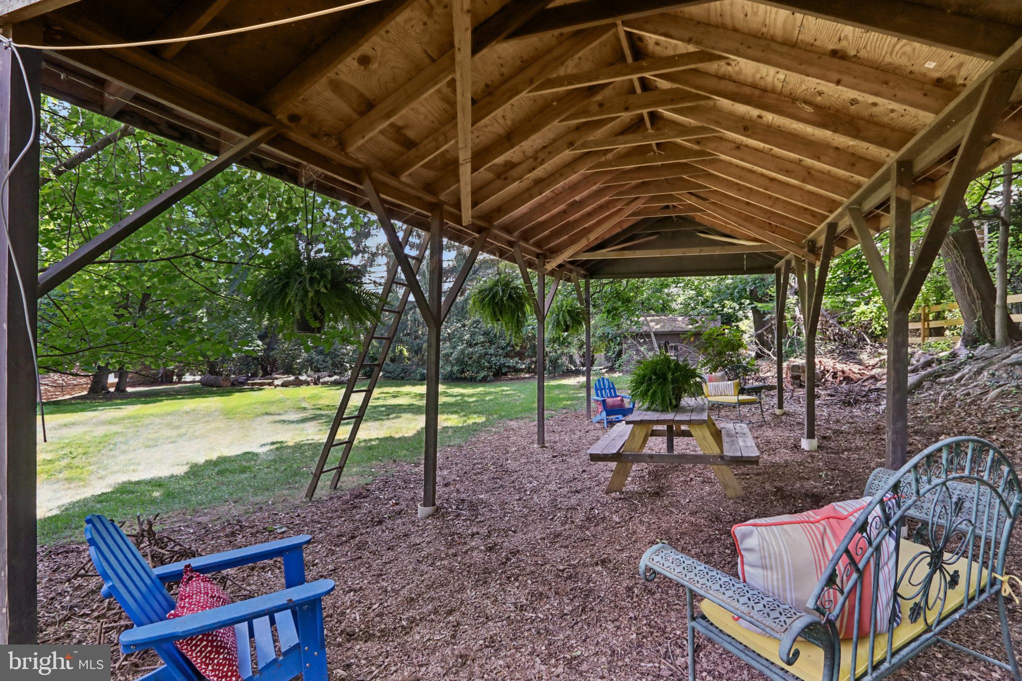 1523 Susquehanna Road Rydal, PA 19046 - Photo 49 of 69 a view of a backyard with table and chairs under an umbrella