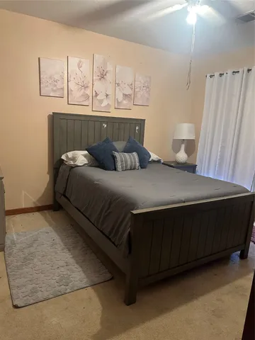 a bedroom with a bed and window