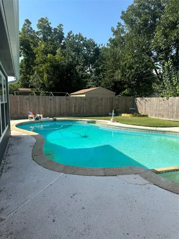 a view of a backyard with small cabin
