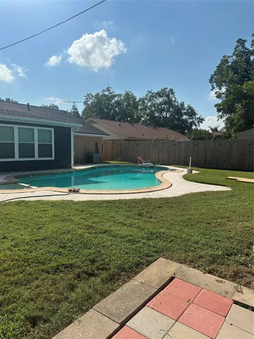 a view of a swimming pool with an outdoor space and seating area