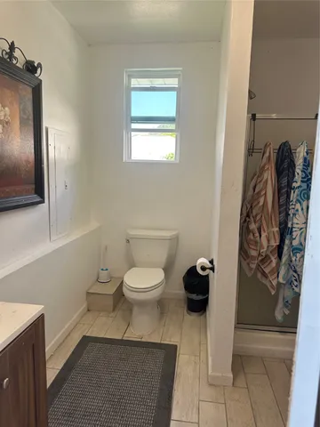 a bathroom with a toilet and a shower