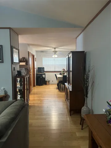 a view of a living room with furniture and a refrigerator