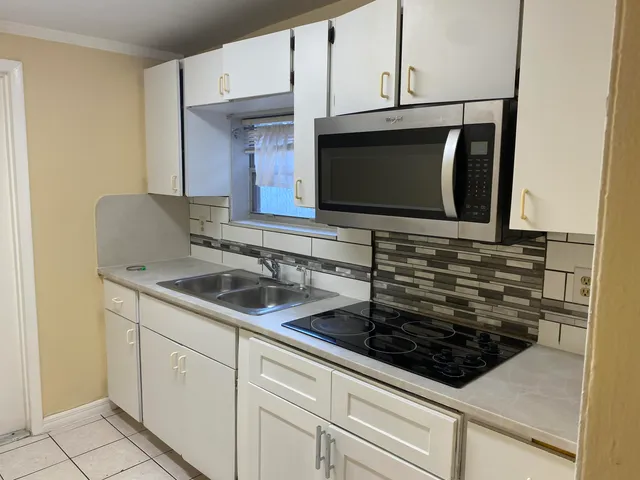 a kitchen with sink stainless steel appliances and cabinets