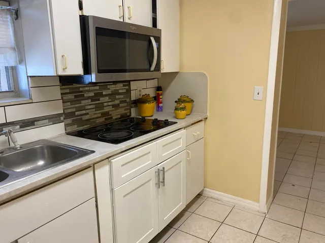 a kitchen with a sink and a microwave
