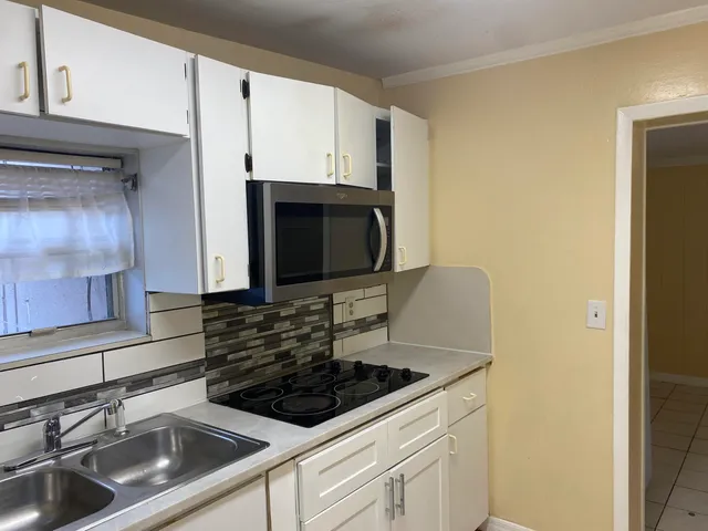 a kitchen with sink stainless steel appliances and cabinets