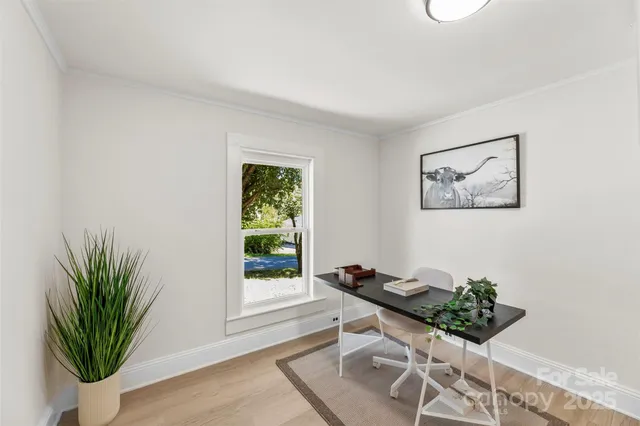 a view of a workspace with furniture and wooden floor