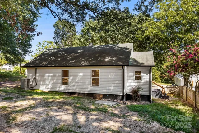 a view of a house with swimming pool and sitting area