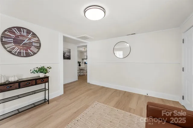 a view of room with furniture and wooden floor