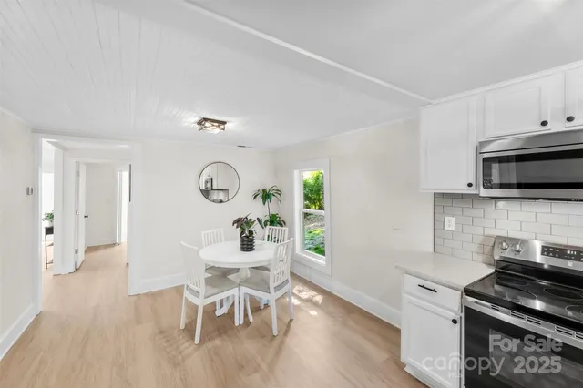 a kitchen with granite countertop a stove and a wooden floors