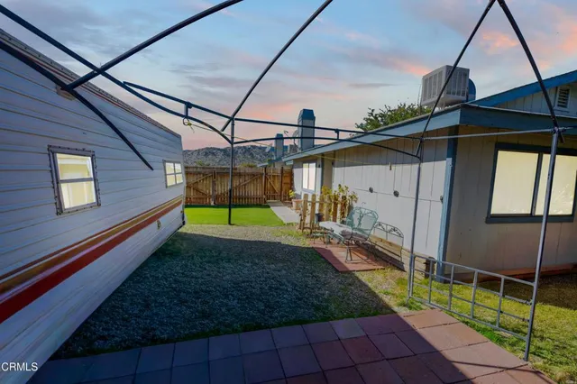 a view of a house with a small yard