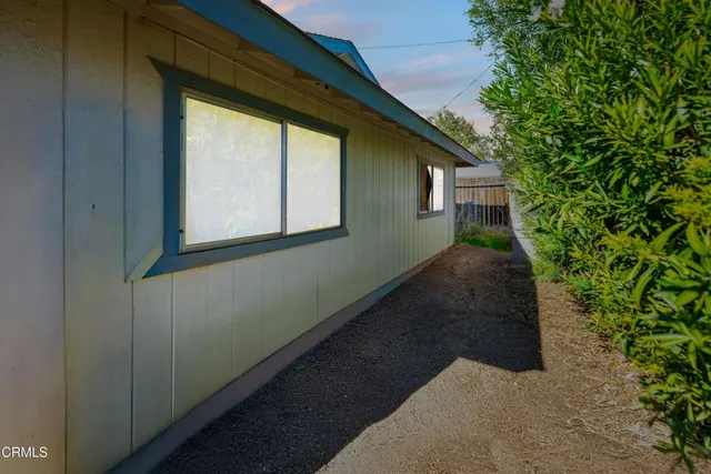 a backyard of a house with large trees