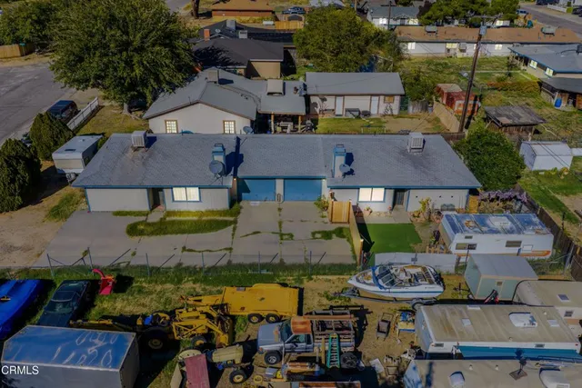 an aerial view of multiple houses with outdoor space