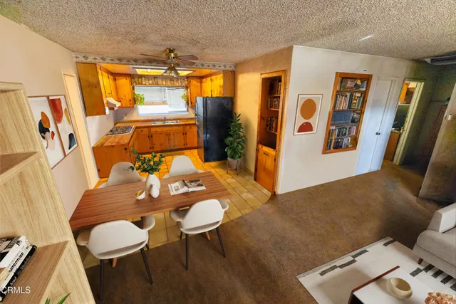 a view of a dining room with furniture and a window