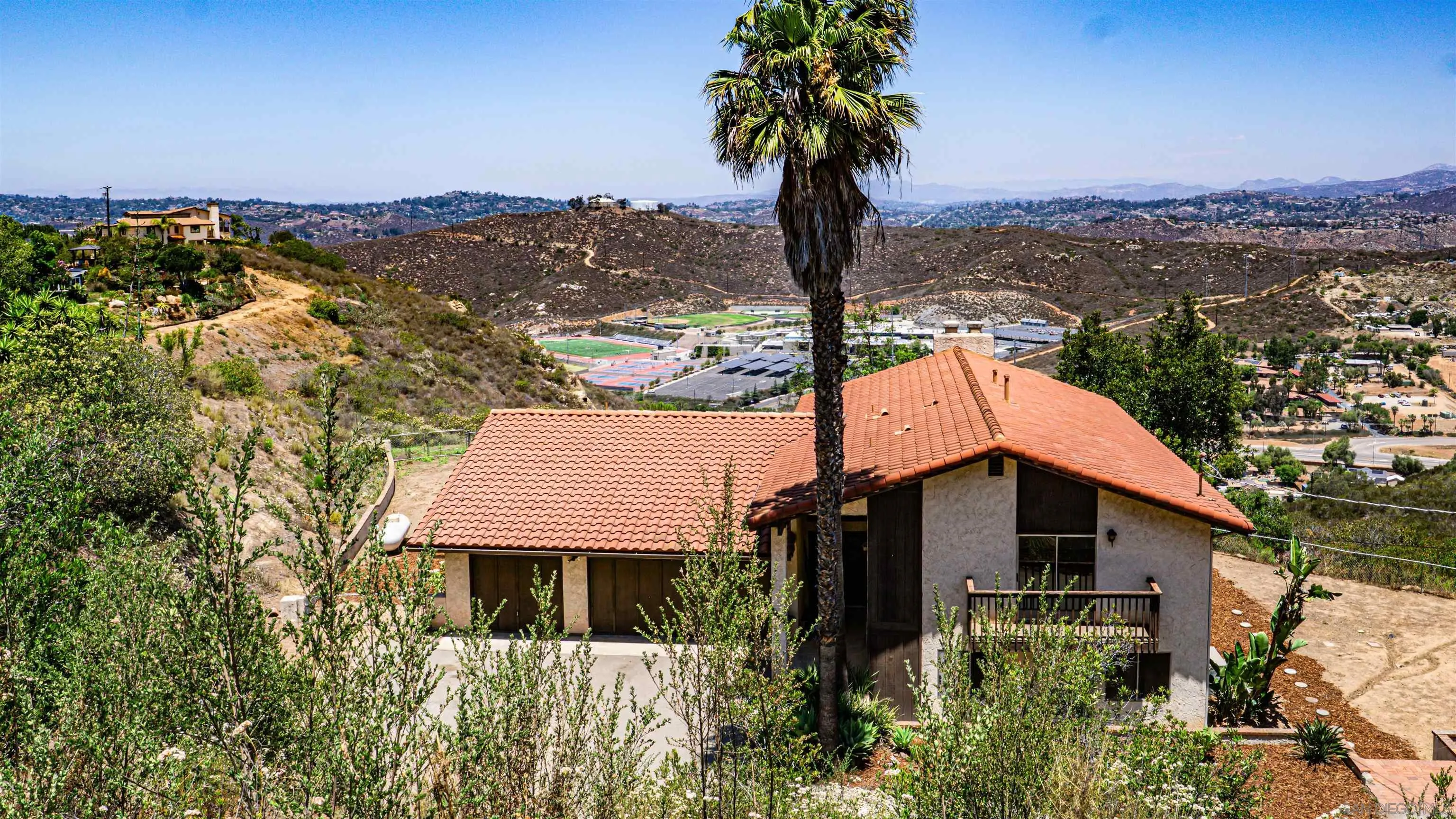 3041 Millar Ranch Road Spring Valley, CA 91978 - Photo 2 of 4 a front view of a house with a garden