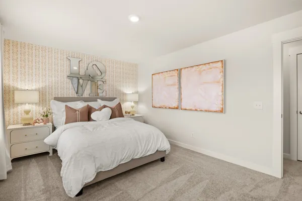 a bed room with a bed mirror and a window