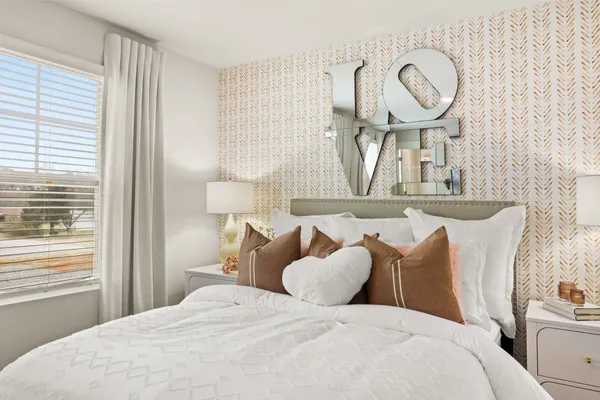 a bedroom with a bed and window