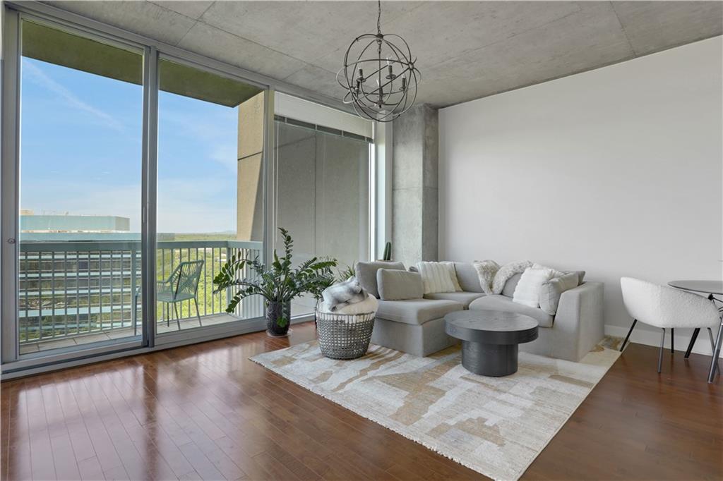 3300 Windy Ridge Parkway Southeast, Unit 1603 Atlanta, GA 30339 - Photo 11 of 36 a living room with furniture and a potted plant