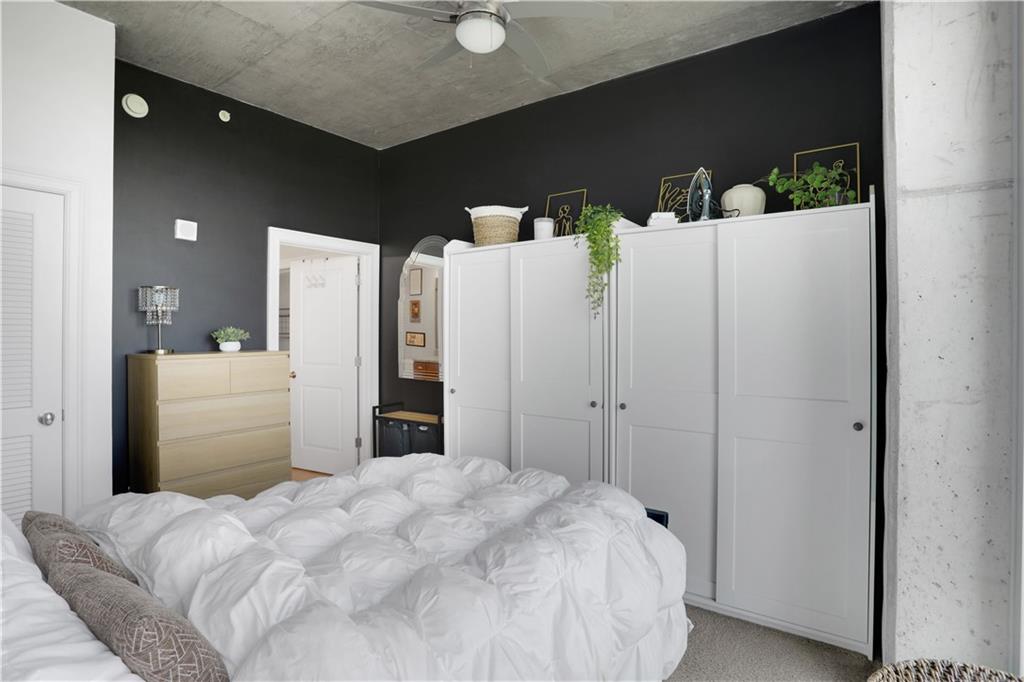 3300 Windy Ridge Parkway Southeast, Unit 1603 Atlanta, GA 30339 - Photo 14 of 36 a bedroom with a bed and a refrigerator