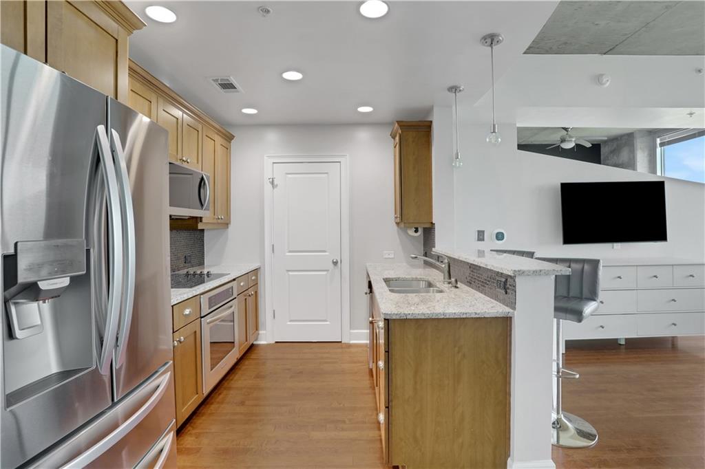 3300 Windy Ridge Parkway Southeast, Unit 1603 Atlanta, GA 30339 - Photo 2 of 36 a kitchen with stainless steel appliances granite countertop a refrigerator and a sink