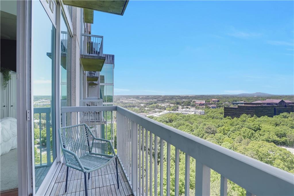 3300 Windy Ridge Parkway Southeast, Unit 1603 Atlanta, GA 30339 - Photo 22 of 36 a view of a balcony with wooden floor and fence