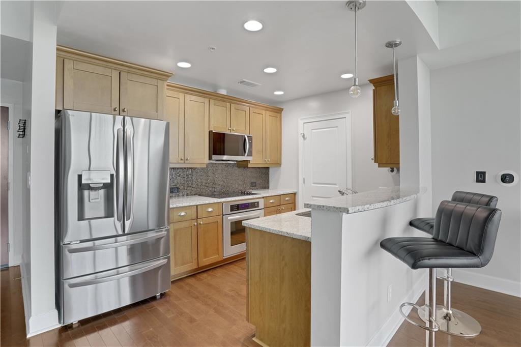 3300 Windy Ridge Parkway Southeast, Unit 1603 Atlanta, GA 30339 - Photo 3 of 36 a kitchen with stainless steel appliances granite countertop a refrigerator and a sink