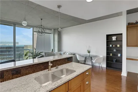 a kitchen with a sink and living room view