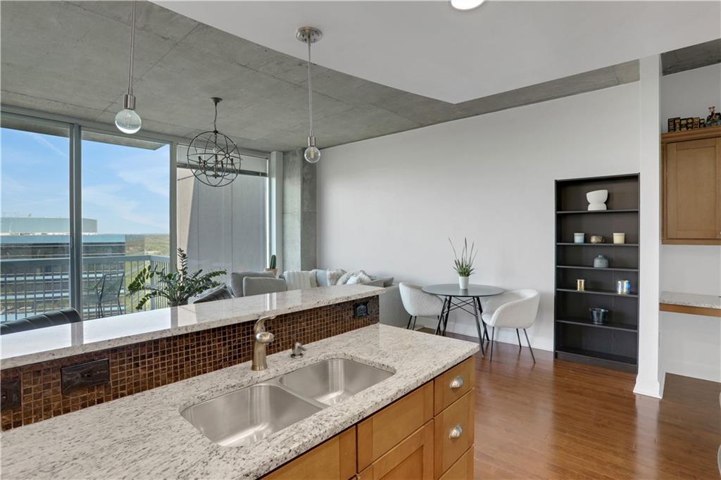 3300 Windy Ridge Parkway Southeast, Unit 1603 Atlanta, GA 30339 - Photo 8 of 36 a kitchen with a sink and living room view