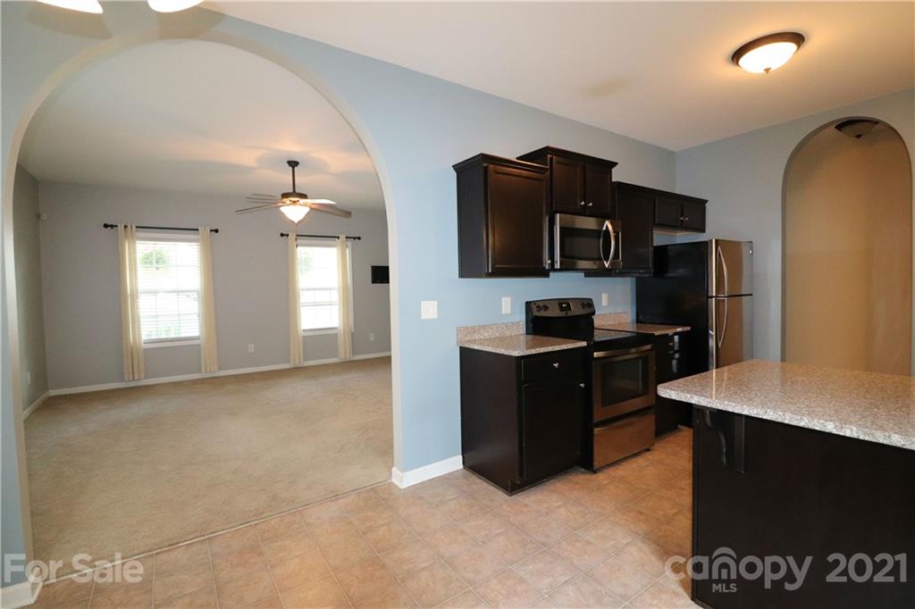 440 Danielle Way Fort Mill, SC 29715 - Photo 4 of 19 a kitchen with a refrigerator and a stove top oven