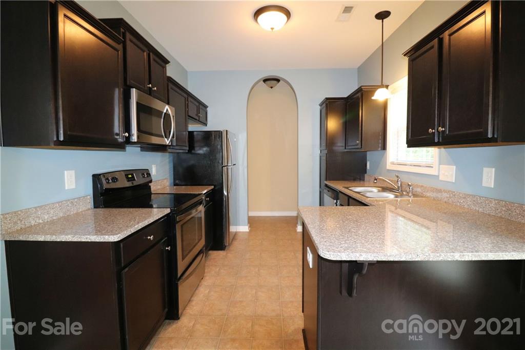 440 Danielle Way Fort Mill, SC 29715 - Photo 7 of 19 a kitchen with stainless steel appliances granite countertop a sink a stove and a refrigerator