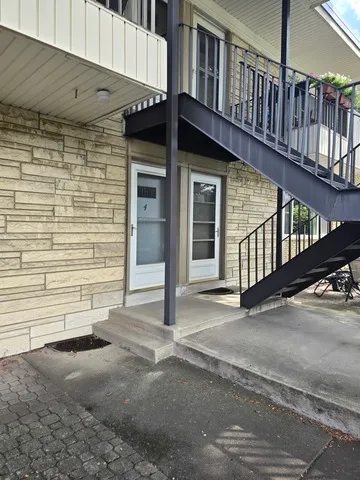 a view of a house with wooden fence