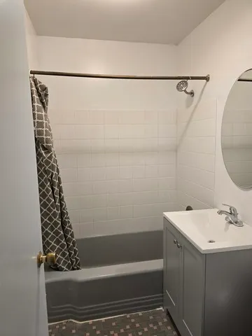 a bathroom with a bathtub a sink and a shower