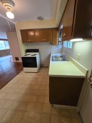 a kitchen with a sink and a stove top oven