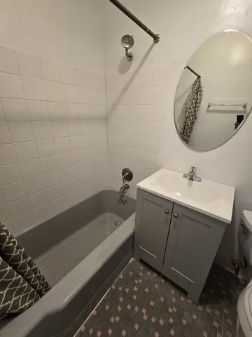 a bathroom with a sink a vanity and bathtub