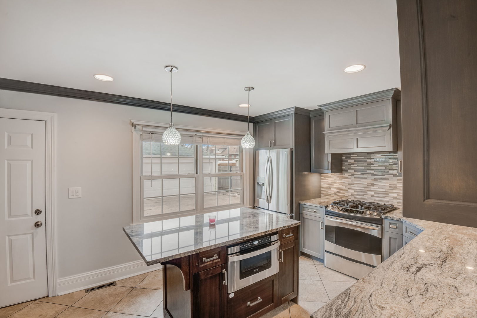 1673 East Algonquin Road Des Plaines, IL 60016 - Photo 11 of 36 a kitchen with stainless steel appliances granite countertop a stove and a refrigerator