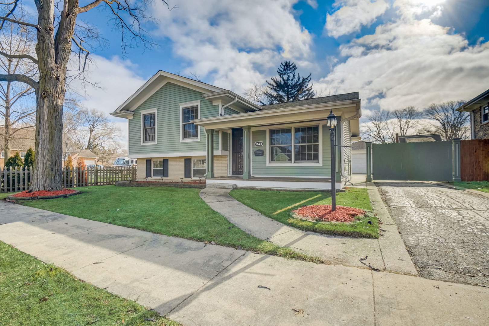 1673 East Algonquin Road Des Plaines, IL 60016 - Photo 2 of 36 a front view of a house with a yard