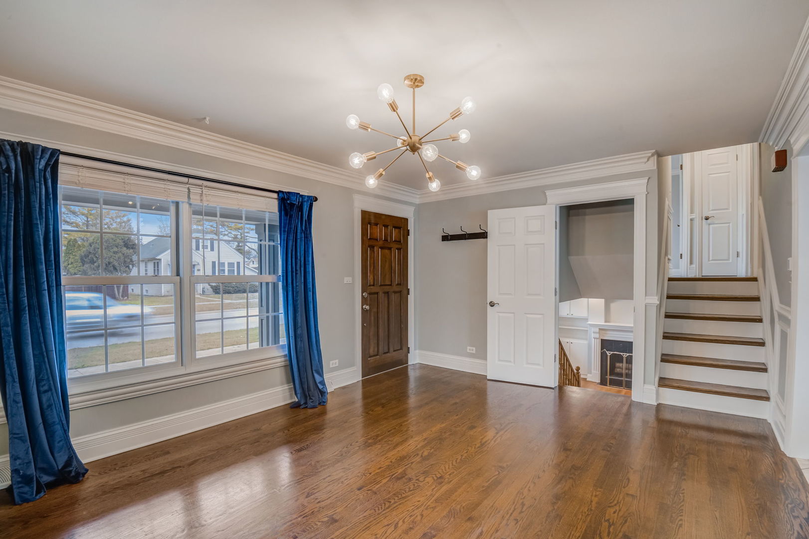 1673 East Algonquin Road Des Plaines, IL 60016 - Photo 3 of 36 a view of a livingroom with wooden floor and a ceiling fan