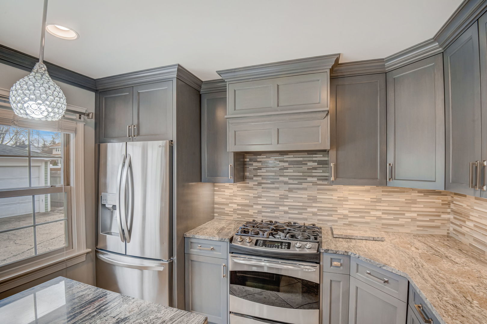 1673 East Algonquin Road Des Plaines, IL 60016 - Photo 9 of 36 a kitchen with granite countertop a refrigerator stove and cabinets